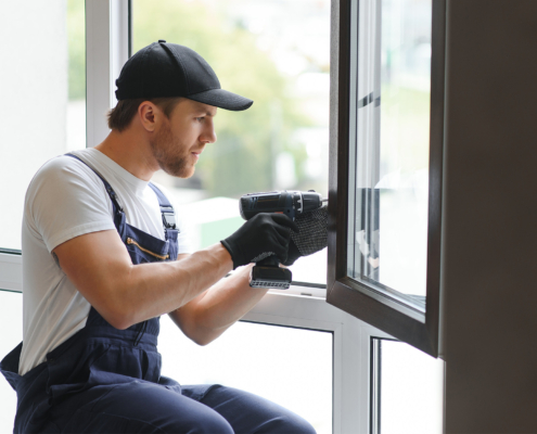 Construction worker installing window