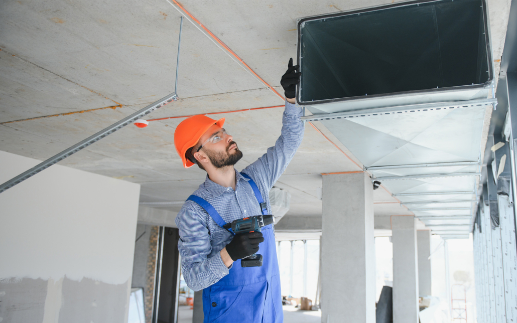 Side view of HVAC technician doing maintenance