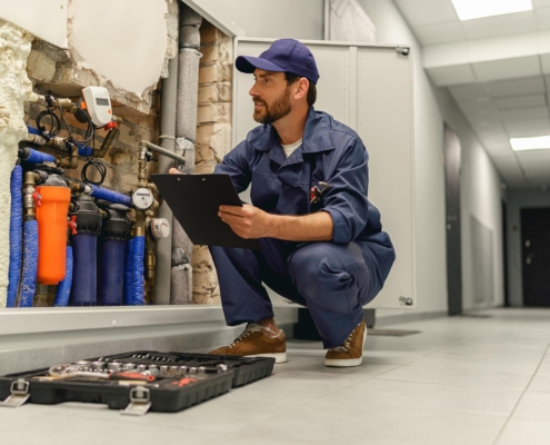 Worker inspecting plumbing system