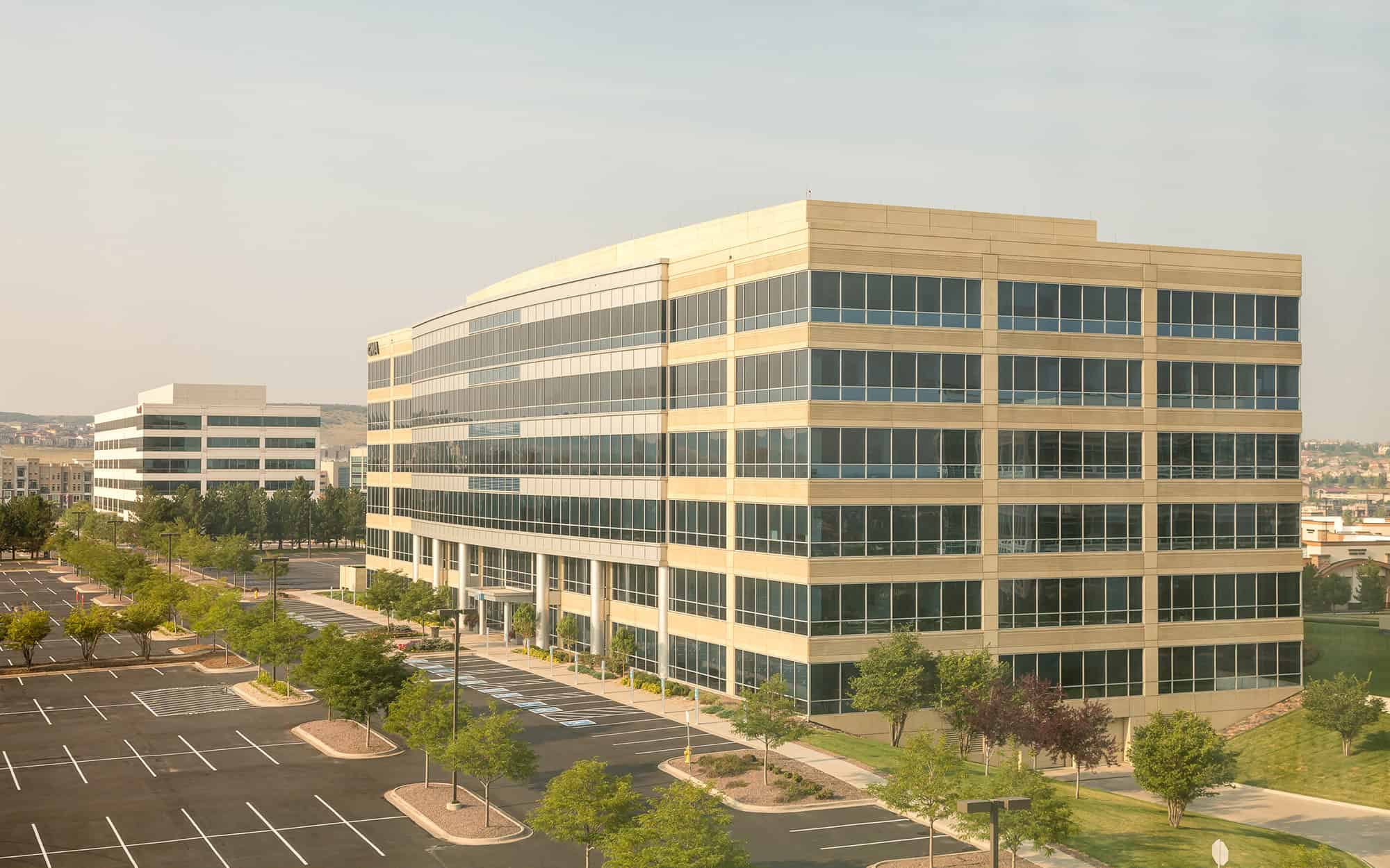 Wide view of White Concrete Office Building with Black Windows