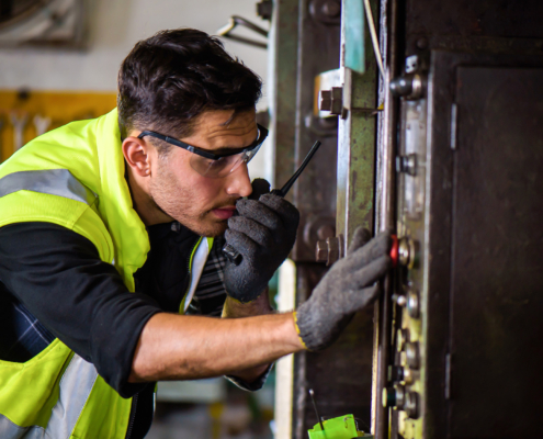 Side view of engineering man checking industrial equipment